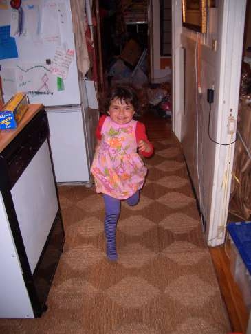 Lila runs through the kitchen