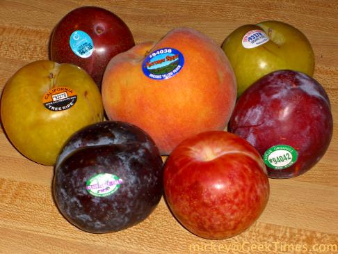 selection of organic plums and a peach