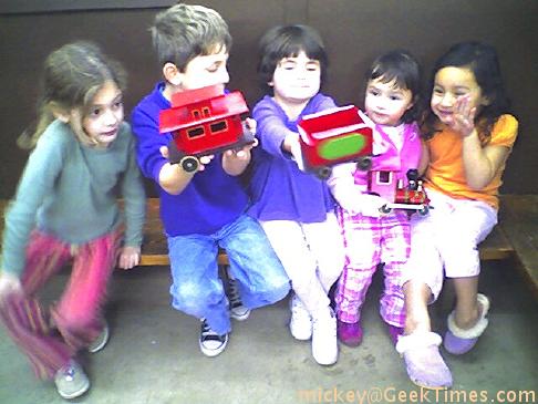 The kids with friend Maddie (at left) and Mir Mir and Belle (at right) at the model railway.
