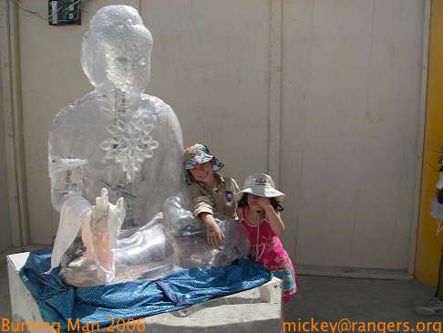 Burning Man 2006: Lila & Isaac enjoy the centering of an ice Buddha